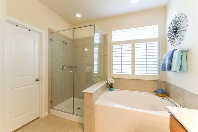 bathroom with plenty of natural light, tile patterned floors, and separate shower and tub