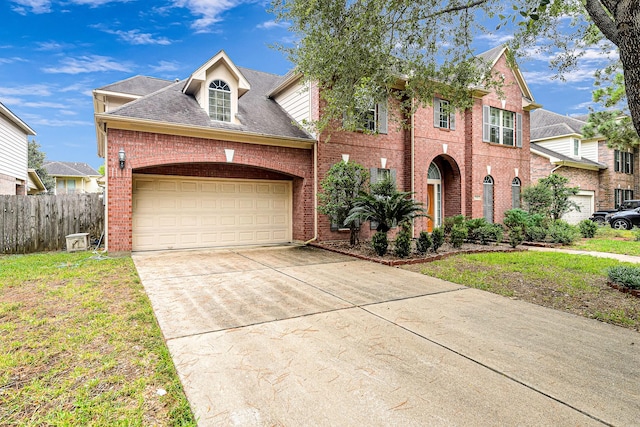 view of front of home with a garage and a front lawn