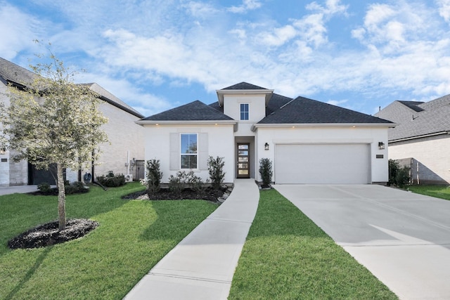 view of front of house with a front lawn and a garage