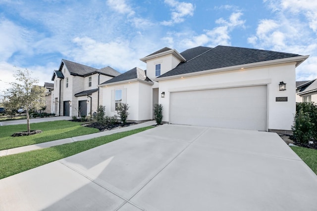 view of front of house with a garage and a front lawn