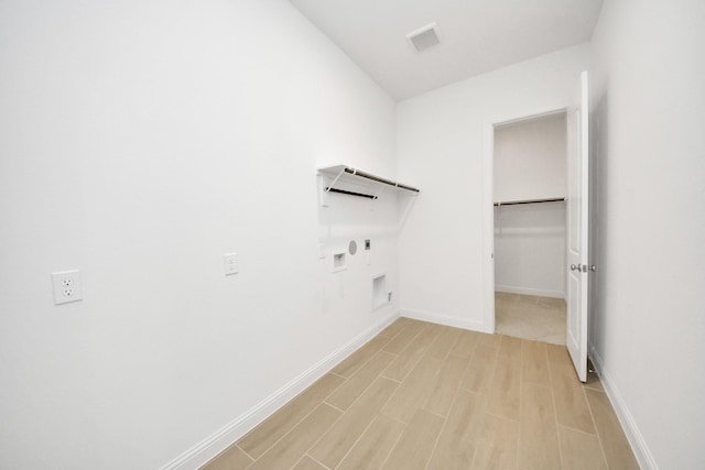 laundry room with washer hookup, gas dryer hookup, electric dryer hookup, and light hardwood / wood-style flooring