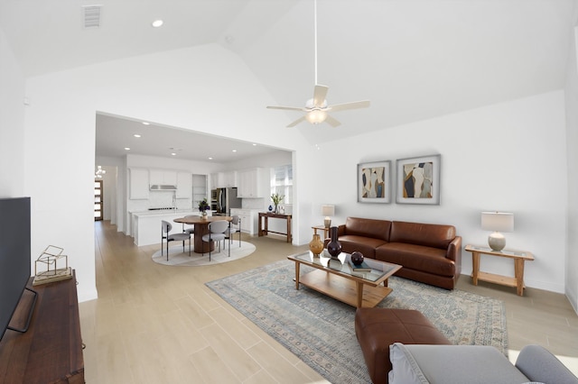 living room featuring ceiling fan and lofted ceiling