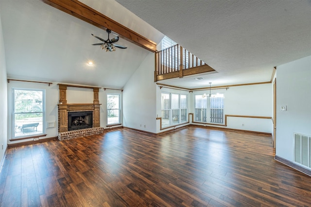 unfurnished living room with ceiling fan with notable chandelier, dark hardwood / wood-style flooring, a brick fireplace, and vaulted ceiling with beams