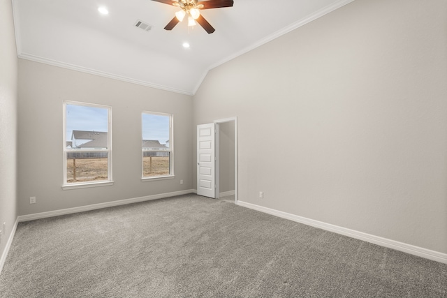 carpeted empty room with ceiling fan, lofted ceiling, and crown molding