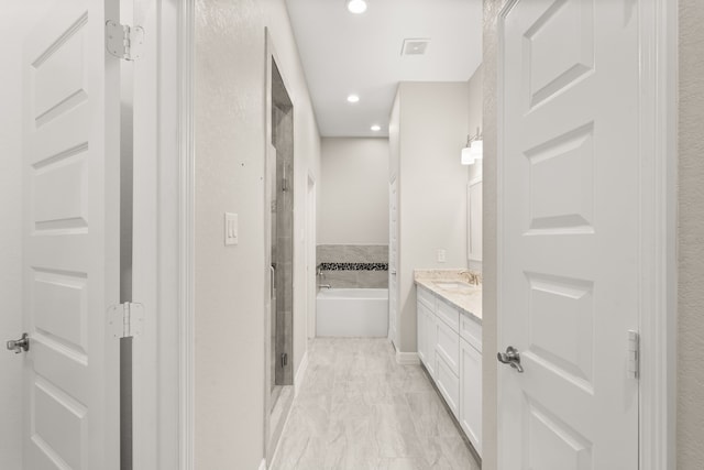 bathroom with vanity and independent shower and bath