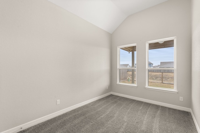 unfurnished room featuring carpet floors and vaulted ceiling