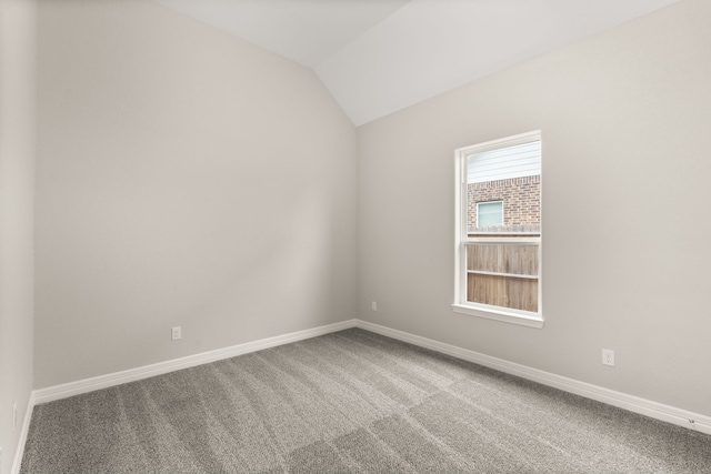 unfurnished room with carpet floors and lofted ceiling