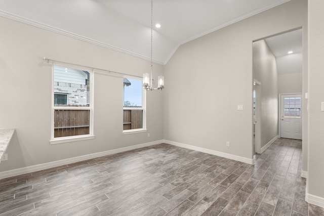 spare room featuring a wealth of natural light, crown molding, lofted ceiling, and an inviting chandelier