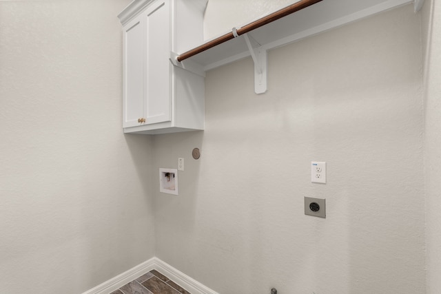 clothes washing area with gas dryer hookup, washer hookup, electric dryer hookup, and cabinets