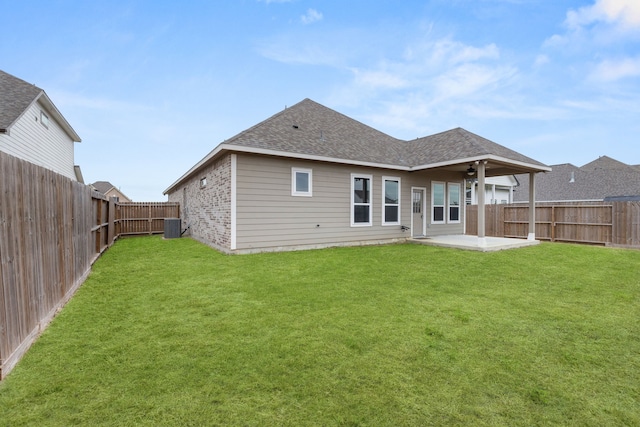 back of property with ceiling fan, central air condition unit, a lawn, and a patio