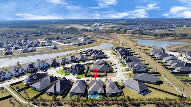 bird's eye view featuring a water view and a residential view