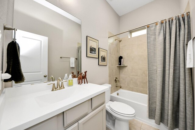 full bathroom with shower / bath combo with shower curtain, toilet, vanity, and tile patterned flooring