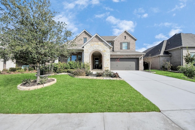 view of front facade featuring an attached garage, concrete driveway, and a front yard