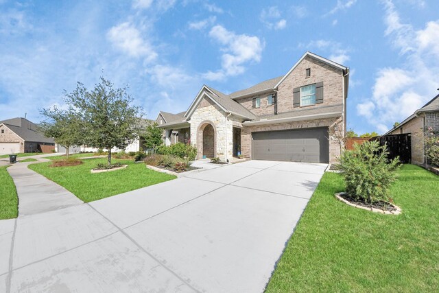 view of front of property featuring a garage and a front yard