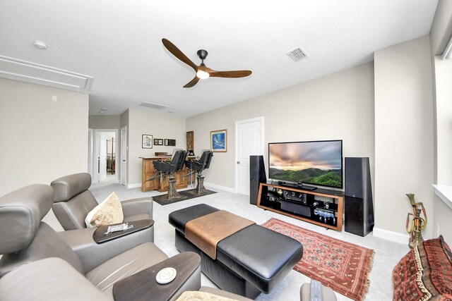 living room featuring light carpet and ceiling fan