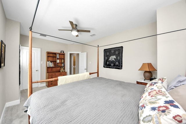 bedroom with light carpet, ceiling fan, visible vents, and baseboards