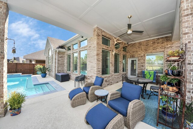 view of patio with ceiling fan and a fenced in pool