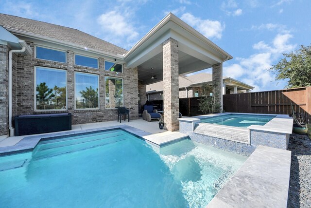 view of swimming pool with an in ground hot tub, a patio area, and ceiling fan