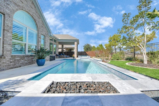 view of pool featuring a patio and a fire pit