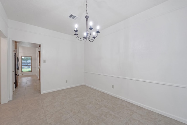 unfurnished room with light tile patterned flooring and an inviting chandelier