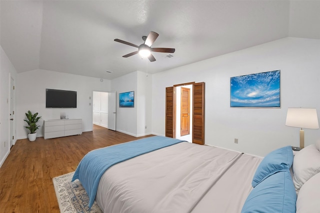 bedroom with vaulted ceiling, ceiling fan, and dark hardwood / wood-style floors