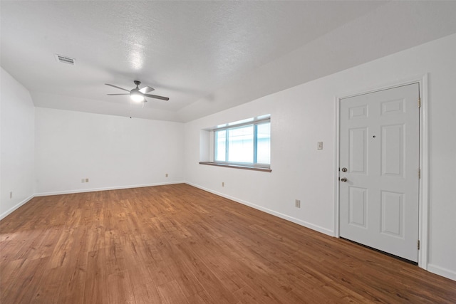 unfurnished room featuring ceiling fan, hardwood / wood-style floors, and a textured ceiling