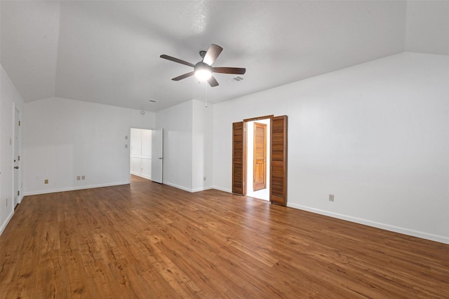 spare room featuring vaulted ceiling, ceiling fan, and wood-type flooring