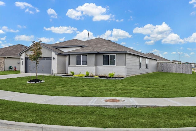 view of front of home with brick siding, an attached garage, fence, driveway, and a front lawn