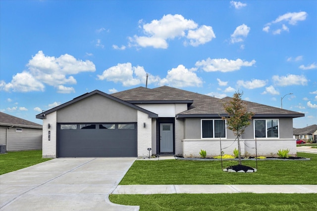 ranch-style home with a garage, brick siding, concrete driveway, a front lawn, and stucco siding