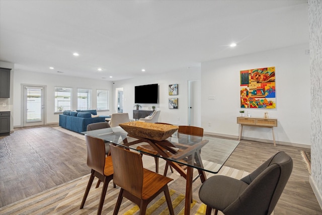 dining area featuring light wood-type flooring, baseboards, and recessed lighting