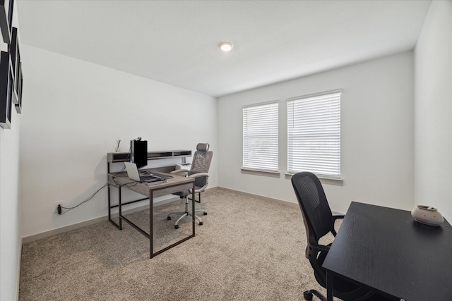 carpeted home office with baseboards