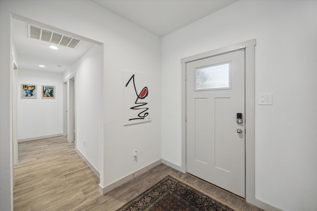 entryway with light wood-type flooring, visible vents, and baseboards