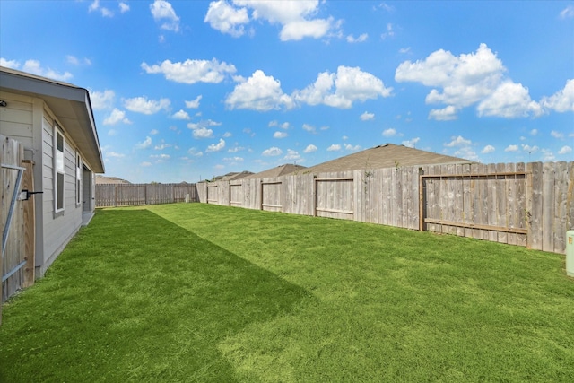 view of yard with a fenced backyard