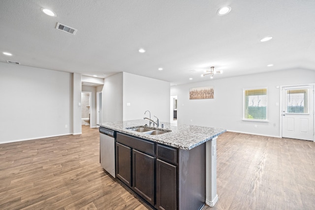 kitchen featuring dishwasher, light hardwood / wood-style flooring, sink, a center island with sink, and dark brown cabinets