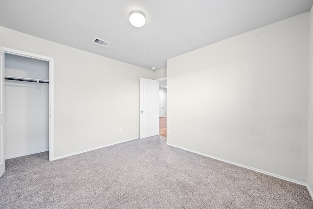 unfurnished bedroom with a closet and carpet floors