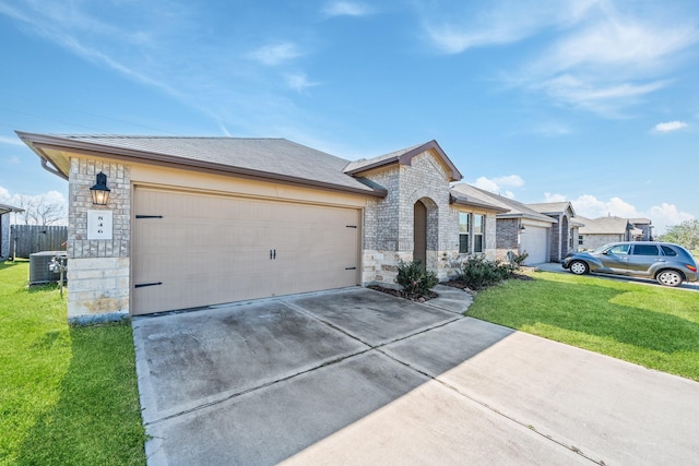 view of front of property with a garage, a front yard, and central AC unit