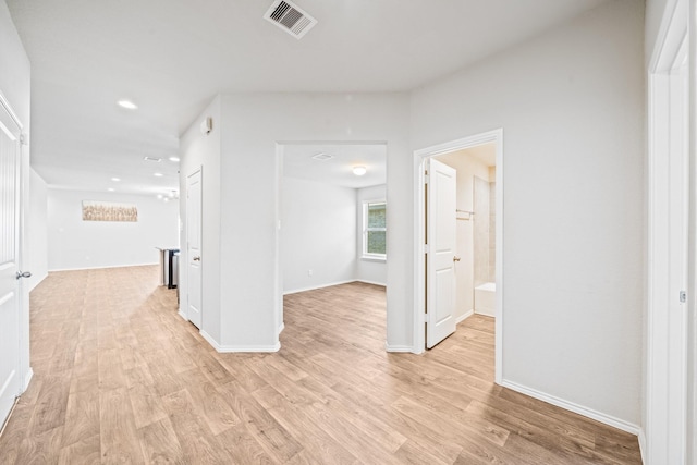 hallway with light hardwood / wood-style flooring