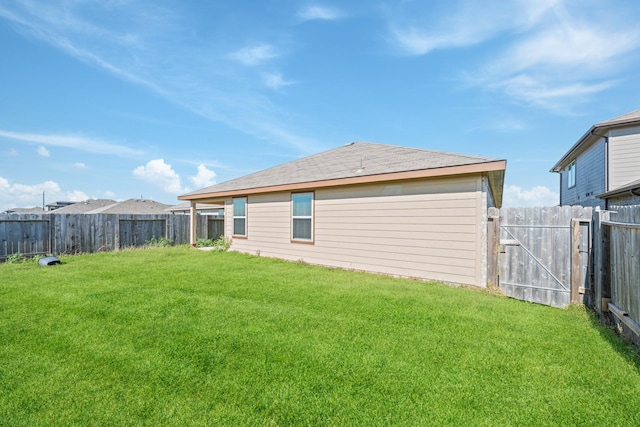 rear view of property with a lawn