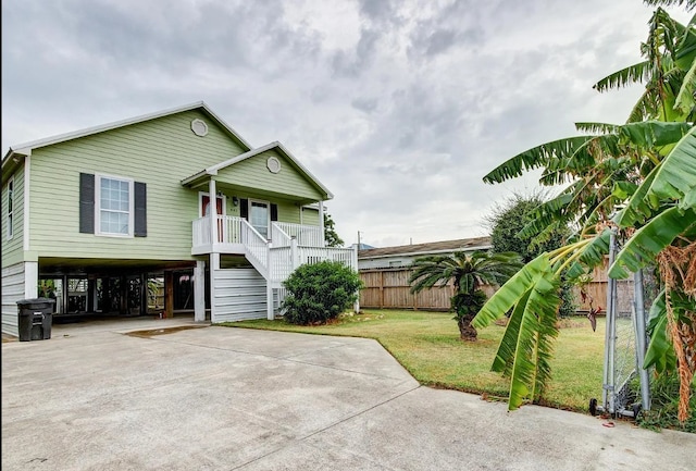 view of front of house with a front yard, covered porch, and a carport