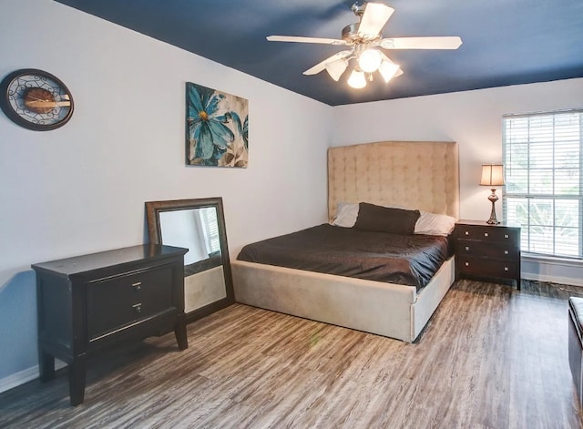 bedroom featuring hardwood / wood-style flooring and ceiling fan