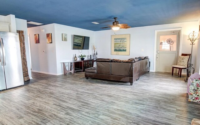 living room with ceiling fan and hardwood / wood-style flooring