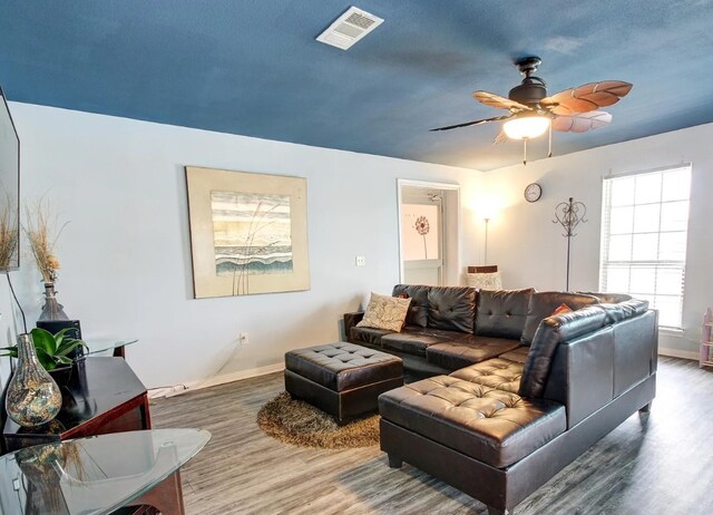 living room with ceiling fan and hardwood / wood-style flooring