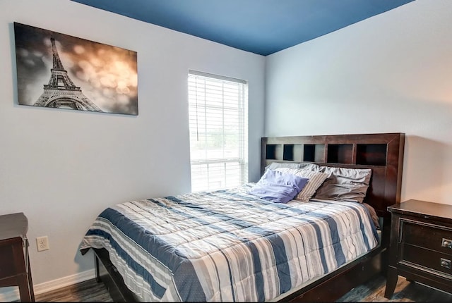 bedroom with dark hardwood / wood-style flooring