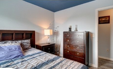 bedroom with dark wood-type flooring