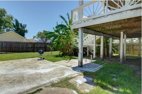 641 4th St, San Leon, TX 77539 - fenced backyard with a patio and stairs