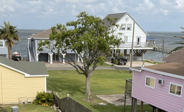 view of yard with a water view and an AC wall unit