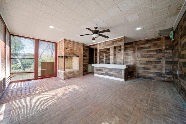 unfurnished living room featuring ceiling fan