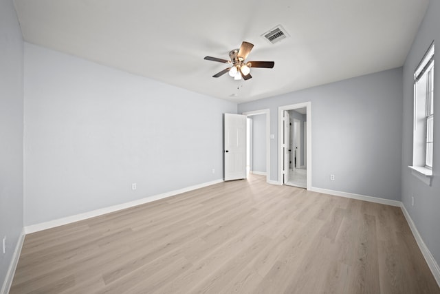 empty room with light hardwood / wood-style floors and ceiling fan