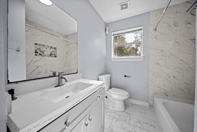 full bathroom featuring toilet, vanity, and tiled shower / bath