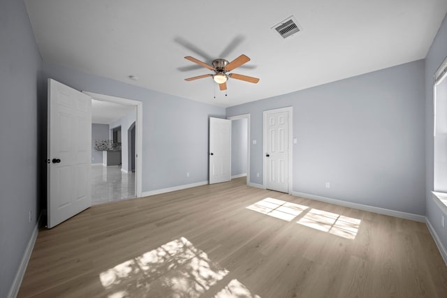 unfurnished bedroom with ceiling fan and light hardwood / wood-style floors